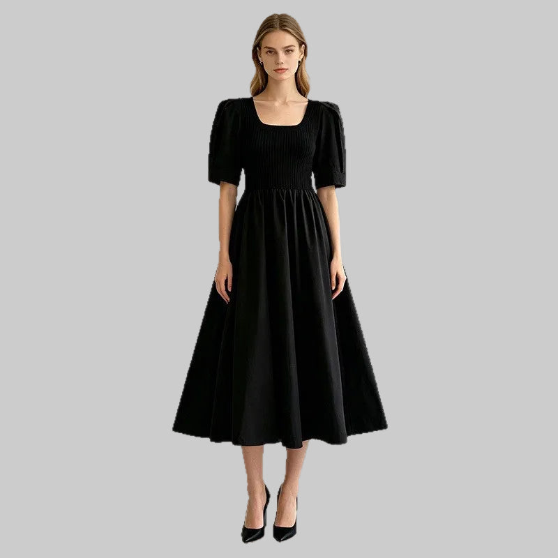 Women's knit dress featuring a square neckline, puff sleeves, and panel splicing detail. Designed with a solid black colorway and a smooth polyester knit construction.